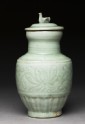 Greenware funerary vase with flowers and a bird