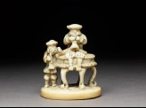 Netsuke in the form of two men playing wind instruments