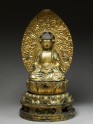 Figure of the Buddha with a mandorla, or halo, seated on a lotus pedestal