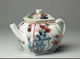 Teapot with two types of flowering plants