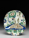 Base fragment of a dish depicting a woman combing her hair (EA1978.1540)