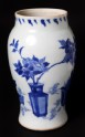 Blue-and-white vase with plants in containers