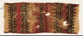 Textile fragment with bands of linked squares, crosses, triangles, and leaves (EA1984.242)