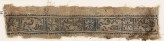Textile fragment with eight-pointed stars and inscription (EA1984.552)