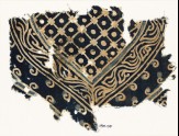 Textile fragment with part of a large medallion with a grid, dots, and a vine (EA1990.194)