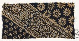 Textile fragment with ornate, dotted, and large rosettes