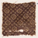Textile fragment with rosettes in a grid of stars and dots