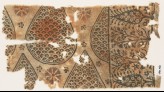 Textile fragment with tear-drops filled with scales, and stylized trees and flowers