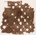 Textile fragment with bandhani, or tie-dye, imitation and rosettes