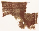 Textile fragment with semicircle, complex rosette, and circle fragment with script (EA1990.597)