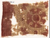 Textile fragment with large medallion, floral shapes, crosses, and circles (EA1990.641)