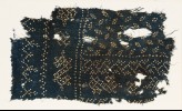 Textile fragment with dots arranged in bands and ovals