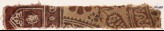 Textile fragment with floral design, small cartouches, and a tab-shape