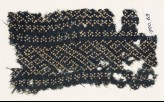 Textile fragment with dots arranged in a geometric pattern