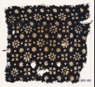 Textile fragment with rosettes, dots, floral shapes, and squares
