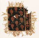 Textile fragment with dots, chevrons, and fringe, possibly from a place-mat or jar cover