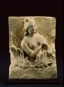 Frieze fragment depicting a female attendant among acanthus leaves