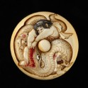 Manjū netsuke depicting Kintarō wrestling with a snake