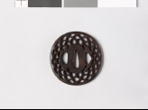 Lenticular tsuba with diaper of overlapping chrysanthemum flowers and leaves