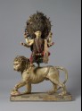 Figure of Durga Mahishasuramardini sitting on a lotus on the back of her lion
