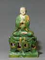 Roof ridge tile in the form of a seated Buddhist figure