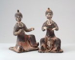 Figure of a seated female attendant with a dog
