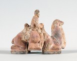 Figure of a man seated on a camel