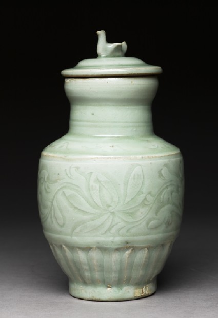 Greenware funerary vase with flowers and a birdside