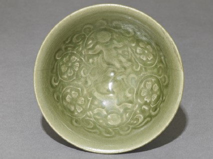 Greenware bowl with boys amid peony scrollstop