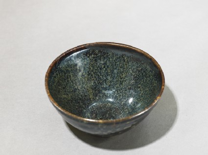 Black ware tea bowl with 'tortoiseshell' glazesoblique