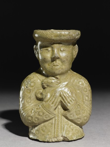 Greenware burial vessel section in the form of man holding a goatfront
