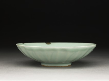 Greenware dish with fluting, and lotus petals on the outsideoblique