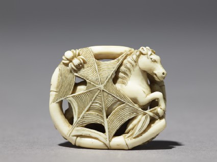 Netsuke depicting a horse caught in a spider's webfront