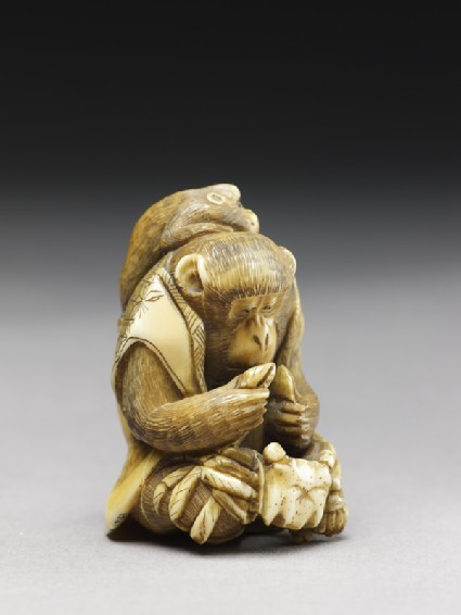 Netsuke in the form of a monkey holding a crabside
