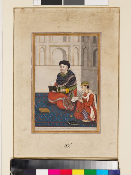 Man, possibly a mullah, reading with a scribefront