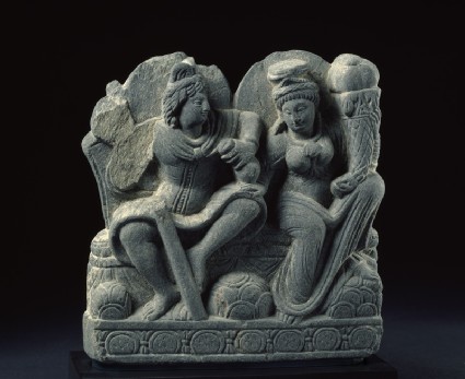 Relief depicting two deities with a staff, purse, and cornucopiaside