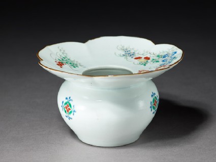Spittoon with flowering plants and butterfliesoblique