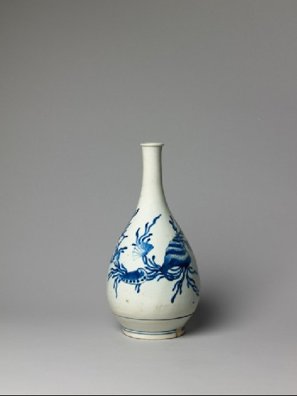 Bottle with seaweed and shell decorationside