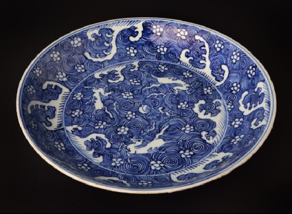 Blue-and-white dish with horses amid wavesfront