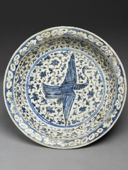Dish with flying crane against a floral backgroundtop
