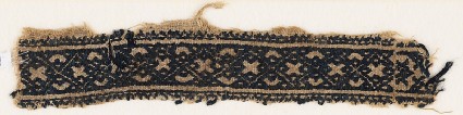 Textile fragment with linked diamond-shapes and crossesfront