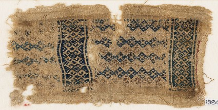 Textile fragment with linked diamond-shapes, hooks, squares, and crossesfront