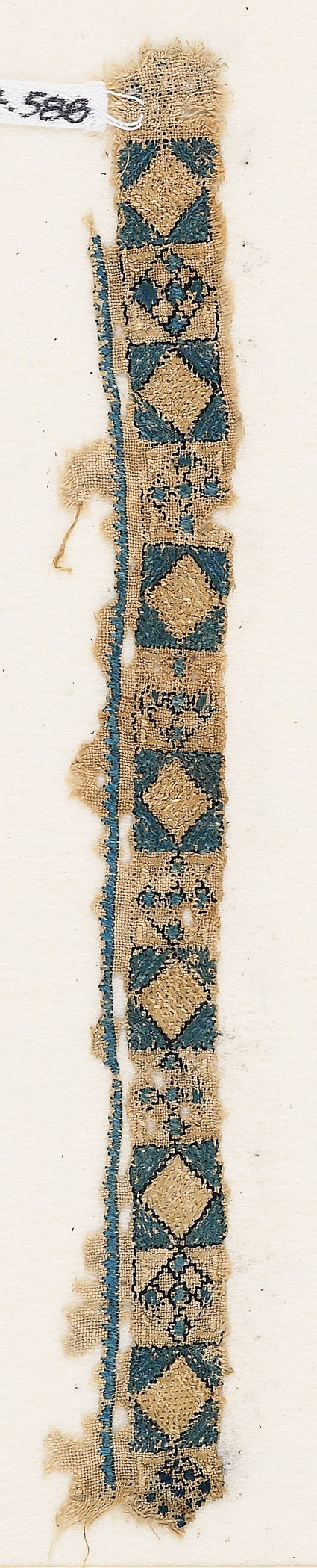 Textile fragment with band of diamond-shapes and crossesfront