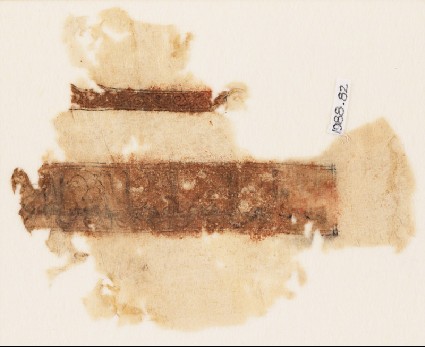 Textile fragment with band of kufic inscription and vine with tendrilsfront