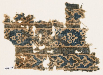 Textile fragment with bands of flowers and elaborate chevronsfront