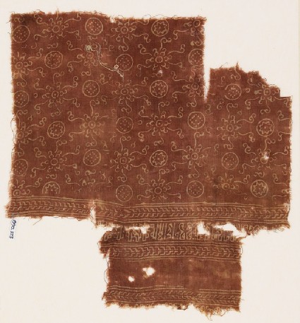 Textile fragment with circles, flowers, rosettes, and kufic-style scriptfront