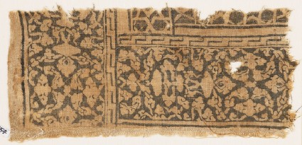 Textile fragment with floral patterns, leaves, and interlacefront