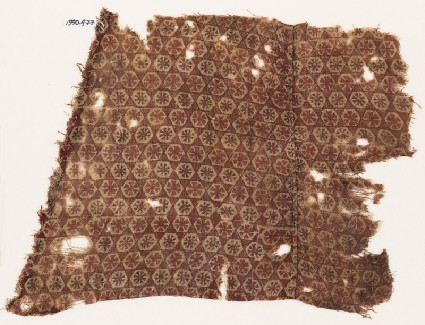 Textile fragment with linked hexagons and rosettes, probably from a garmentfront