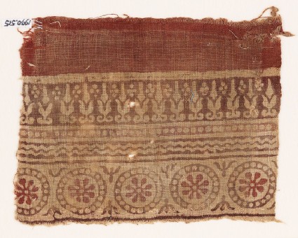 Textile fragment with rosettes in dotted circles, and abstract plantsfront