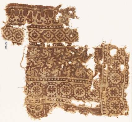 Textile fragment with bands of rosettes in dotted circles, spirals, and diamond-shapesfront
